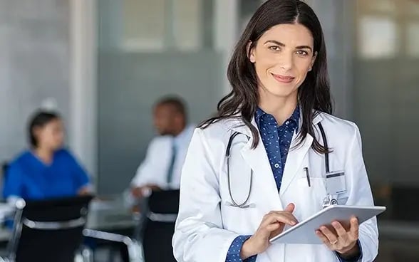 Doctor holding digital tablet-588x368