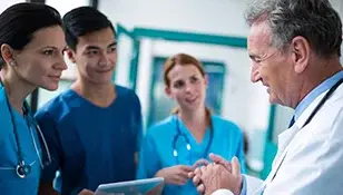 doctor-addressing-team-308x175